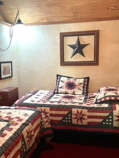 Second bedroom has 2 twin beds covered with handcrafted quilts
